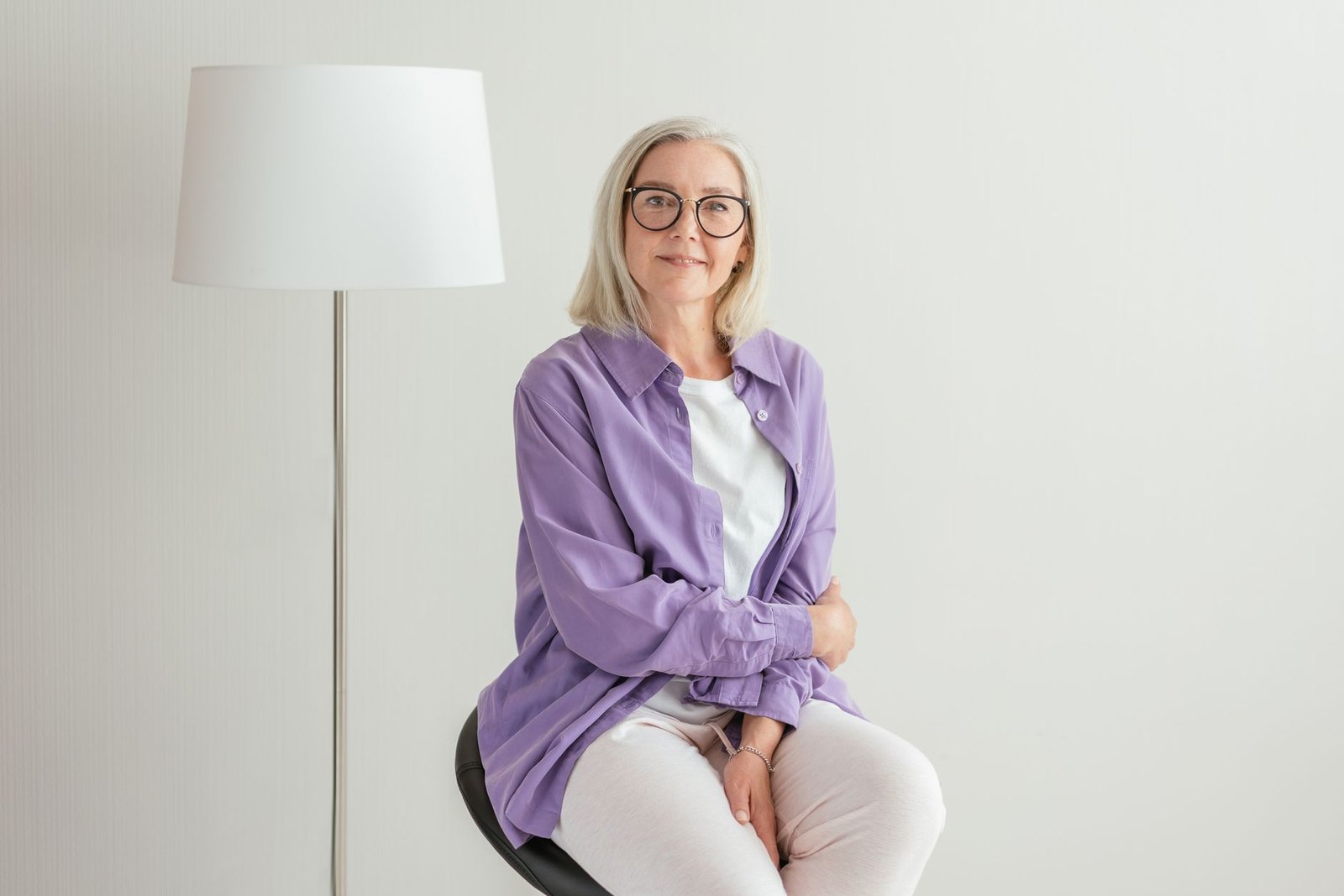 A woman in her sixties sitting calmly, looking at the camera